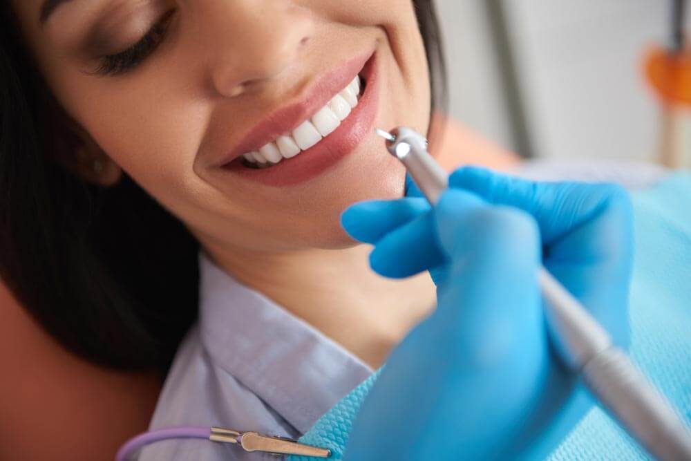 Woman having dental treatment at dental clinic
