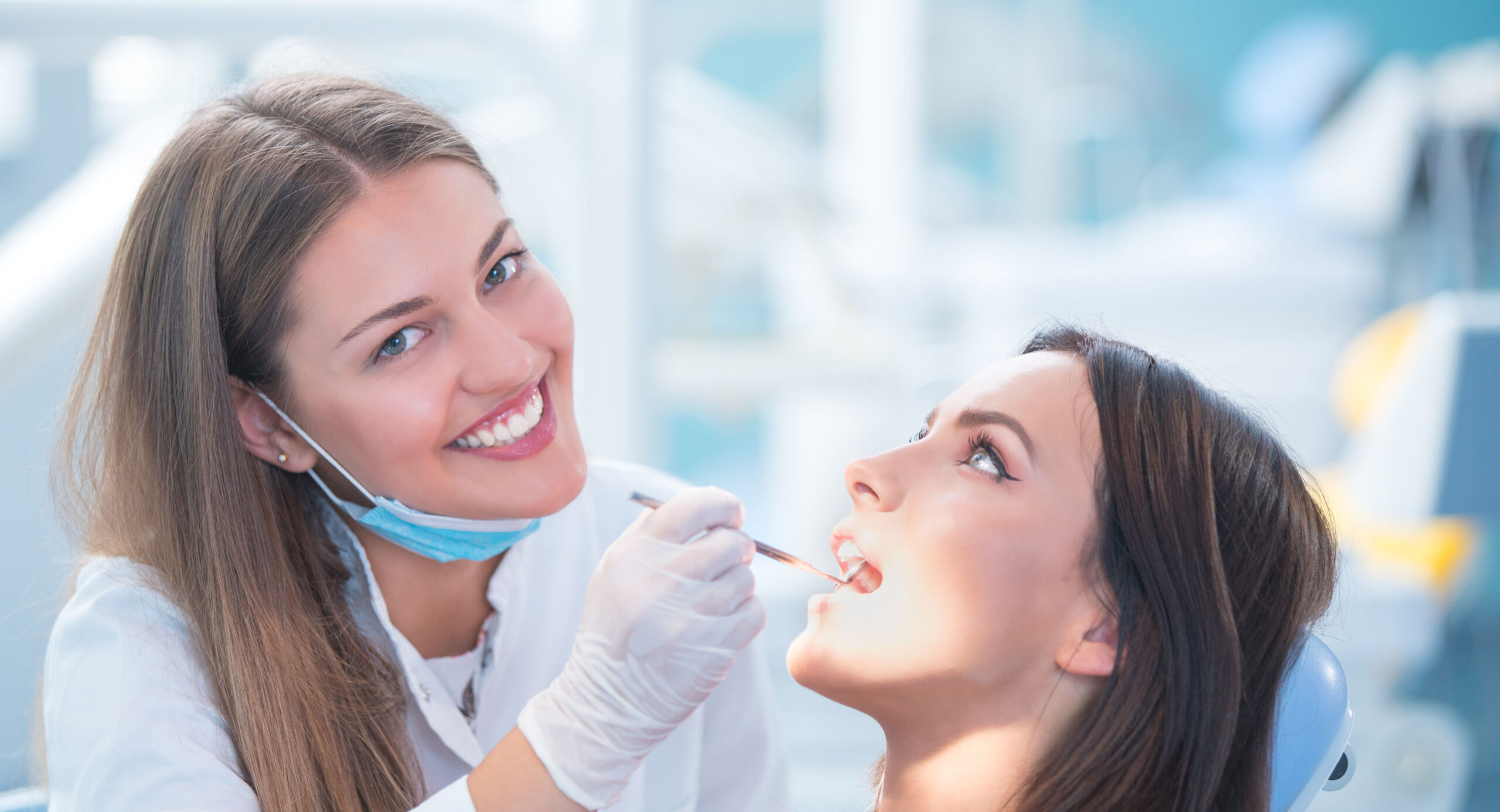 Dental Hygienist cleaning her patient's teeth